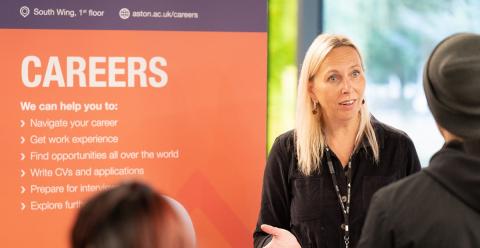 Aston University careers event poster with woman giving a talk