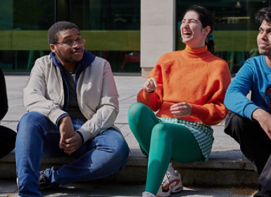 Students laughing and talking outside Birkbeck, University of London